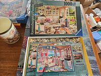 Ravensburger The Tea House box top and Ravensburger The Beach Hut pieces visible