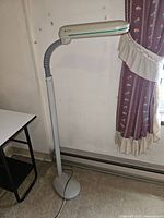 Full view of OttLite fluorescent task lamp on stand