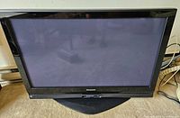 Front view of Panasonic TH-42PX75U plasma TV on stand