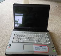 Laptop open showing screen, keyboard and palm rest labels