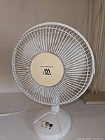 Front view of WeatherWorks table fan showing grill, blades, control buttons