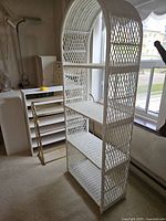 Side view of white wicker arched etagere