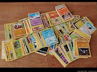 Top view of numerous face-up Pokémon cards spread in piles