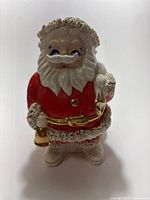 Front view of ceramic Santa coin bank