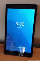 Tablet front powered on displaying lock screen