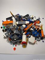 Top view of pile of assorted LEGO pieces on white surface
