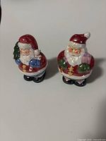 Front view of both Santa shakers