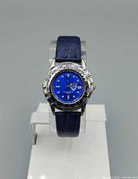 Front view showing blue dial, bezel, strap