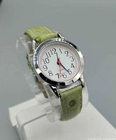 Front view showing dial, numerals, second hand, case and strap