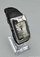 Front angled view of watch displaying dial, case and strap