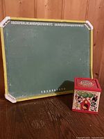 Green chalkboard side with alphabet and numbers alongside jack-in-the-box