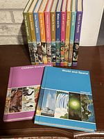 Spine view of Childcraft volumes 3-15 on shelf