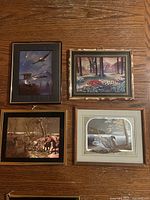 All four framed foil art pieces on wall