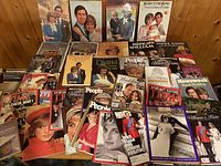 Spread of first group of magazines and softcover books featuring Diana, Charles, William, Harry