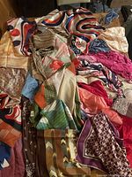 Tabletop view showing majority of scarves with varied patterns and colours
