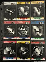 Front view of nine Pro Set logo cards in plastic sheet