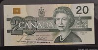 Obverse of 1991 $20 banknote showing Queen Elizabeth II portrait, denomination, Bank of Canada text