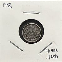 Reverse of 1998 Canada 5-cent silver coin in cardboard holder, showing denomination, maple wreath and dates