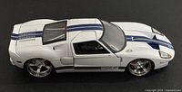 Driver-side profile of white 1:24 Ford GT with blue stripes and chrome wheels