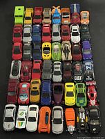 Top-down view of all 48 die-cast vehicles arranged in six rows of eight