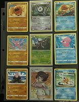 Front view of nine Pokémon cards in plastic binder page showing card names and HP values