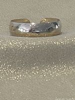 Frontal view of sterling cuff bracelet showing engraved pattern