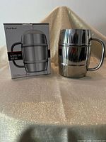 Mug beside retail box showing product and branding