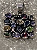 front of sterling pendant showing multicoloured gemstones