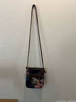 Full view of purse hanging to show size and strap length