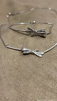 Bracelet and necklace showing matching bow design and stone accents