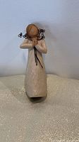 Front view of Willow Tree Friendship figurine holding wire flowers