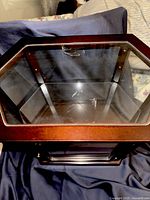 Top view of hexagonal glass display case showing mahogany frame and glass lid