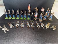 Group of die-cast soldiers in two rows showing variety of uniforms, poses and instruments