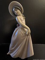 Front view of Lladro Little Iris figurine showing hat, dress and stance