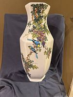 front view showing bird and floral painting on vase