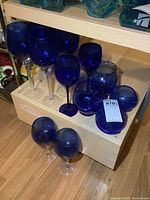 Group of cobalt blue goblets and rose bowls on shelf