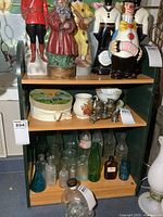 Front view of green display shelf with wood-tone shelves