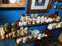 Overall view of wooden rack filled with salt and pepper shakers on three shelves