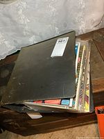 Closed black binder filled with comics