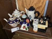 Group shot of all seven teapots on shelf