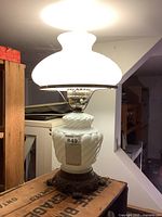 Full lamp lit showing glass shade, body, and metal base