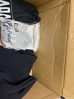 View into box showing black fabric and sealed Focus package