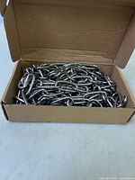 Open box showing coiled stainless steel chain