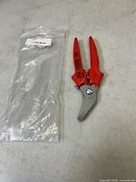 Full view of Erdi snip beside plastic sleeve