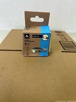 Front view of boxed McKINLEY junior LED headlamp