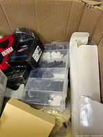 Overview of open box showing earbud tip organizer and various packaged items