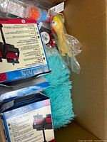 Box with AquaTech filter boxes, squeaky dog toys, spiky balls, teal cushion