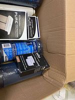 Box containing blue carbon block cartridges, Electrolux filter boxes, Braun filter pack