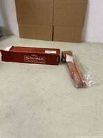 Seam roller and stiletto bagged beside Savina box