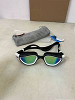 Goggles front view with case and tags